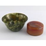 A green jade turned bowl, 9.5cm. dia. and a turned agate box, 6cm. dia.