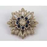 A yellow and white metal (tests 9 carat gold and silver) sapphire and diamond star brooch,