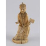 A carved ivory figure of a deity wearing a garland,