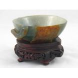 A Chinese jade bowl carved as a hollowed peach on a branch with a bat. 13x13x4cm.