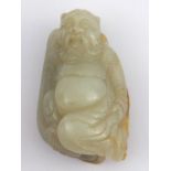 A Chinese jade figure of a bearded man on his knees, a leaf or fruit behind. Ht. 5.5cm.