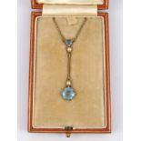 An Edwardian 15 carat gold aquamarine and seed pearl pendant,