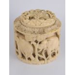 An ivory box, circa 1920, the thick walls with elephants and trees in high relief,