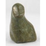 An Inuit carved greenstone study of a seated penguin, signed Eva Itulu. ht.11cm.