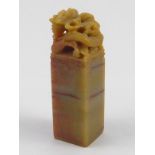 A Chinese hardstone seal , the capital carved with a dragon seizing the flaming pearl. Ht. 7cm.