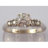 A white metal (tests 18ct gold) five stone diamond ring,