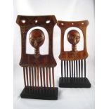 A pair of Ashanti tribe combs, each with a head on a tall ringed neck, circa 1960, on later stands.