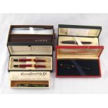 A set of two red lacquer fountain pens with gilt mounts in fitted case,