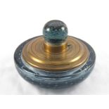 A large circular brass mounted glass inkwell, the grey glass body and lid incorporating bubbles.