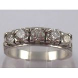 A white metal (tests 18 carat gold) five stone diamond ring,