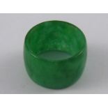 A jade pendant of fine colour, approx 8.7mm wide, 14mm diameter.