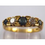 A yellow metal (tests 18 carat gold) five stone sapphire and diamond ring,