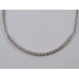 A white metal (tests 18 carat gold) cubic zirconia necklace. Approx. 43cm long, 18.3gms.