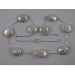 A white metal (tests silver) cultured “coin” pearl necklace, pearls approx 14mm wide,