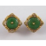 A pair of yellow metal (tests 18 carat gold) jade and diamond earrings, jades approx 10mm diameter,