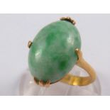 A yellow metal (tests 18 carat gold) jade ring,