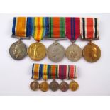 A group of WW I and II medals complete with ribbons and matching miniatures,