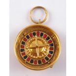 An unusual 18 carat gold pendant, one side set with gemstones, the other a rotating roulette wheel,