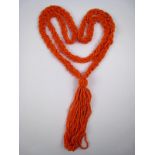 A coral bead plaited sautoir necklace, beads approx 2mm, necklace approx 76cm long, 1cm wide,