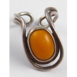 A stylised silver and amber ring, hallmarked London 1980, maker LL, amber approx 14.5 x 10.