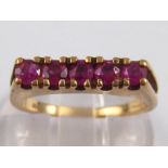 A 9 carat gold five stone ruby ring, size N, 2.8 gms.