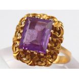 A yellow metal (tests 18 carat gold) synthetic purple sapphire ring, stone approx 10 x 8mm,