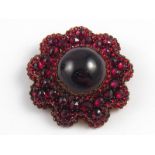 An antique “Bohemian garnet” brooch, the principal cabochon garnet measuring approx 2cm diameter,