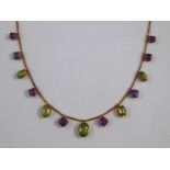 An Edwardian 15 ct gold, peridot and amethyst necklace. The principal peridot measuring 8x6.2mm.