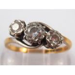 A yellow and white metal (tests 18 carat gold) three stone diamond ring, marked 18ct plat, size N,