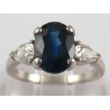 A platinum diamond and sapphire ring, the sapphire measuring approx 9 x 7mm, ring size L, 5.3gms.