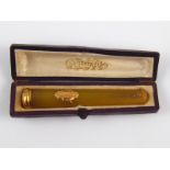A French hallmarked 18 carat gold and amber cigar holder, approx 8cm long, in original box.