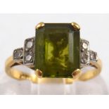 An 18 carat gold peridot and diamond ring, the peridot measuring approx. 7x9mm, size H, 3.3gms.