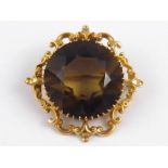 A yellow metal (tests 9 carat gold) citrine brooch with pendant fitting, approx 5cm wide, 37.1 gms.