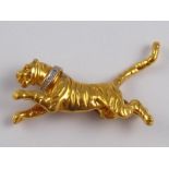 A 9 carat gold brooch, designed as a tiger with a diamond collar, approx 5cm long, 5.5 gms.