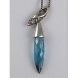 A white metal (tests 18 carat gold) blue topaz pendant necklace, topaz approx 15mm, necklace approx.