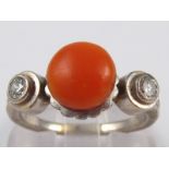 A French hallmarked platinum, coral and diamond ring, coral approx 8.5mm diameter, ring size O, 7.