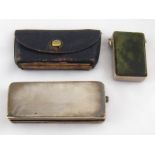 A leather purse vesta case, complete with vestas, striking on sandpaper strip on base,