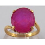 A yellow metal (tests 18 carat gold) ruby ring, the colour enhanced ruby measuring approx 14 x 12mm,