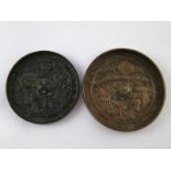 Two oriental bronze mirrors, 10cm. and 11cm. diameter.