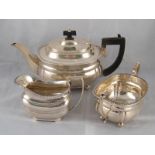 A three piece silver teaset, barge shaped with gadrooned rim,