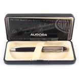 A boxed silver topped Aurora ball point pen .