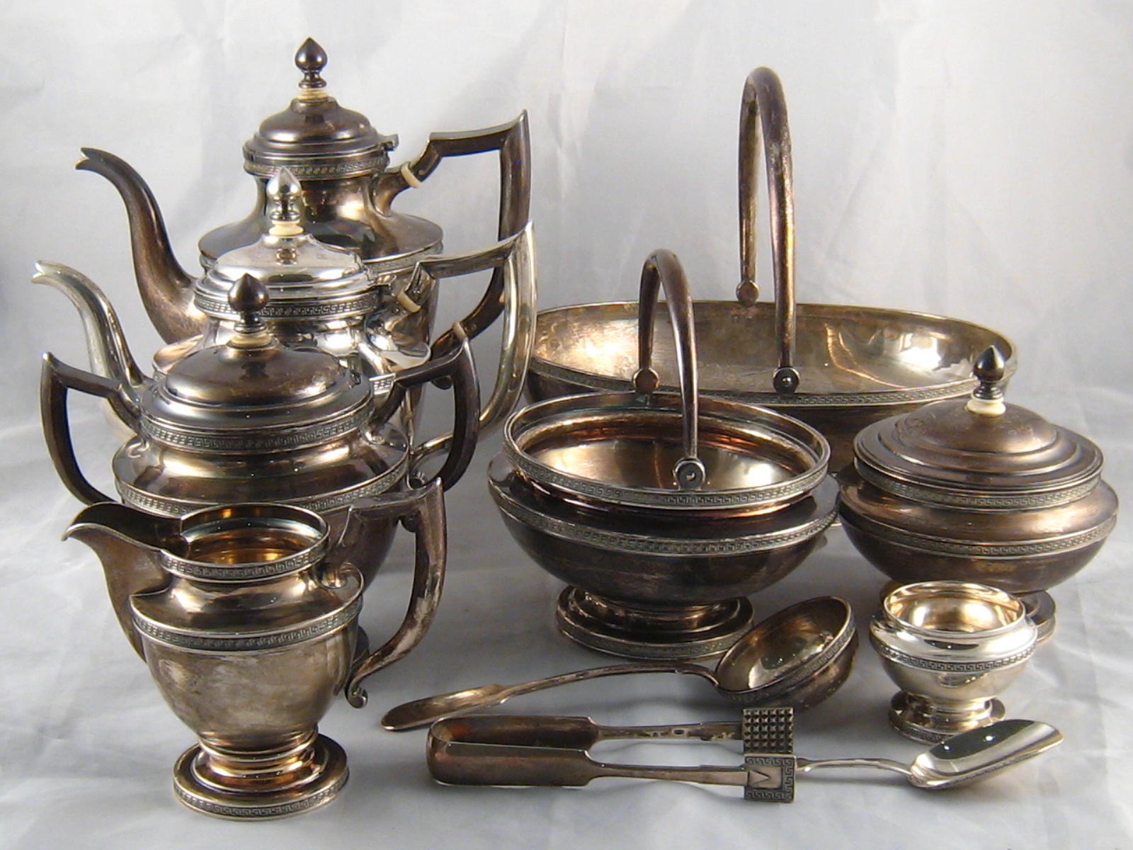 A comprehensive Russian silver tea equipage, comprising a seven piece tea set,