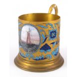 A Soviet Russian gilt cloisonne enamelled metal tea glass holder with freehand painted enamel