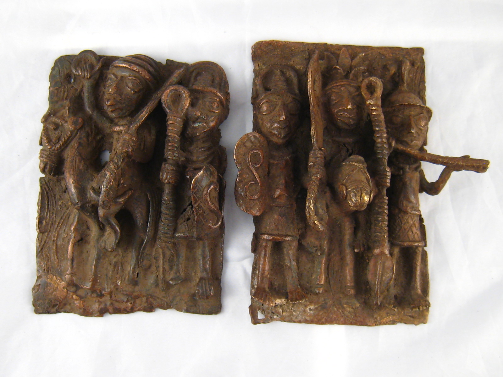 Tribal Art . Two Nigerian bronze plaques in high relief, 17x10 and 16x11 cm.