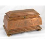 A silk lined sarcophagus shaped gilt bronze jewel casket on flattened ball feet. 20x10x11cm. high.