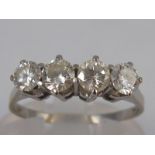 A white metal (tests 18 carat gold) four stone diamond ring, estimated total diamond content 0.75-0.