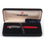 A boxed Aurora ball point pen with silver cap.