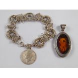 A mixed lot comprising a white metal (tests silver) amber pendant,