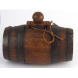 A small coopered oak brandy barrel with iron bands and ball stopper. 19cm. long x 10cm. diameter.