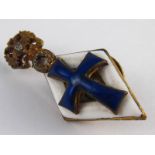 A Russian silver lady's university lapel badge bearing an enamel cobalt blue cross on a white